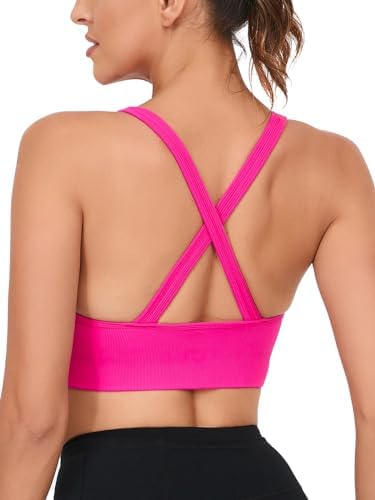 A pullover sports bra in dark pink with a crisscross back, lined shelf construction, and removable pads for medium-to-high support.