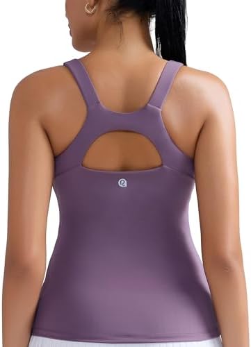 A scoop neck athletic tank with an integrated shelf bra, molded removable cups, and crisscross racerback straps in purple.
