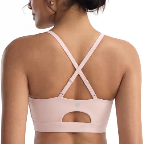 Molded cups sewn directly in place, paired with adjustable cross-back straps and a wide stay-put underband in soft pink.