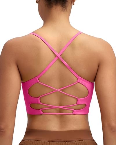 A seamless knit sports bra with crisscross back straps, removable pads, and a wide roll-resistant hem in bright hot pink.