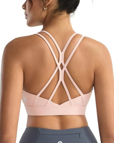 A high-impact pullover bra in baby pink, built with multi-strap crisscross back panels and removable molded cups.