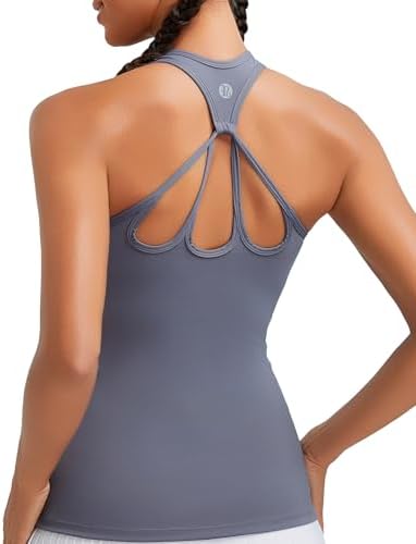 A racerback workout tank in deep purple with a built-in shelf bra, removable pads, and a wide interior underband.