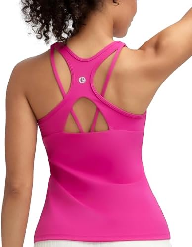 A racerback yoga tank with an integrated shelf bra, molded removable cups, and open strappy back detailing in bright hot pink.